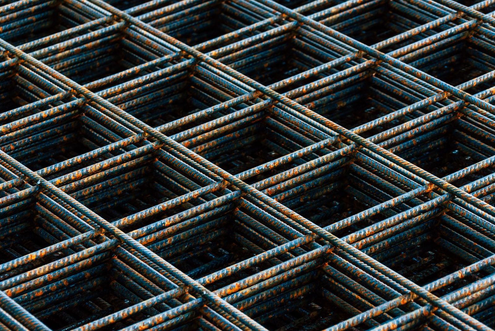 Stacked sheets of reinforcing mesh waiting to be tied into a slab